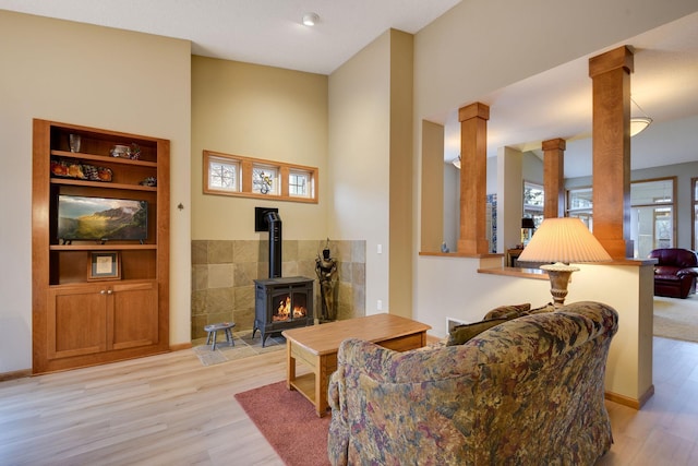 7232 Kestrel Trl, Savage, MN 55378 - living area with decorative columns, light wood finished floors, and a wood stove