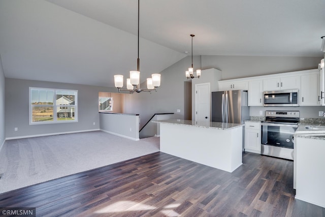 1102 2nd St NW, Delano, MN 55328 - kitchen with appliances with stainless steel finishes, a kitchen island, white cabinetry, and a notable chandelier