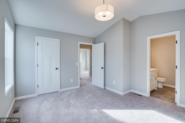 1102 2nd St NW, Delano, MN 55328 - unfurnished bedroom featuring visible vents, carpet flooring, vaulted ceiling, and multiple windows