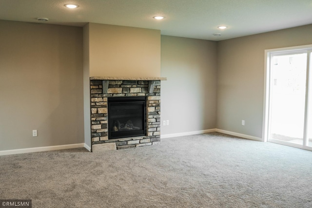 1102 2nd St NW, Delano, MN 55328 - unfurnished living room with carpet floors, baseboards, a fireplace, and recessed lighting