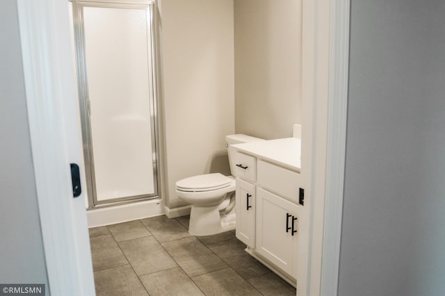 1102 2nd St NW, Delano, MN 55328 - bathroom featuring tile patterned flooring, a stall shower, toilet, and vanity
