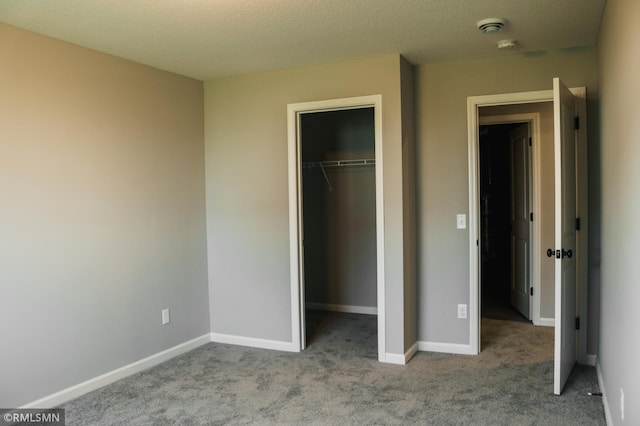 1102 2nd St NW, Delano, MN 55328 - unfurnished bedroom featuring a closet, carpet flooring, baseboards, and a spacious closet