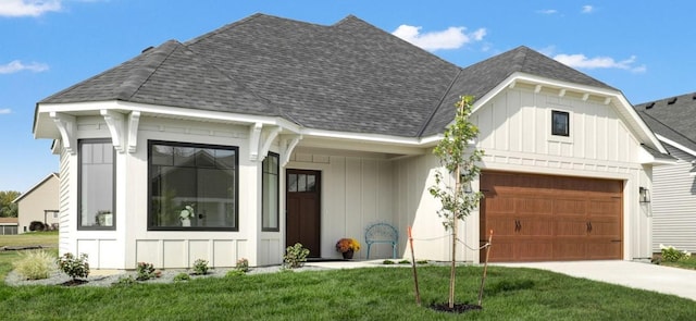 view of front of home featuring board and batten siding, roof with shingles, and driveway