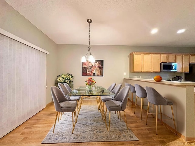 dining room with light wood-type flooring and recessed lighting