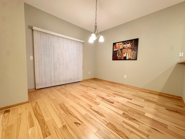 unfurnished room with light wood-style floors and baseboards