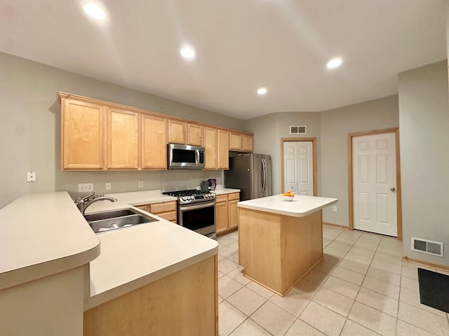 kitchen featuring appliances with stainless steel finishes, light brown cabinetry, a sink, light countertops, and recessed lighting