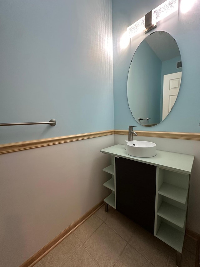 bathroom with vanity, baseboards, and tile patterned floors