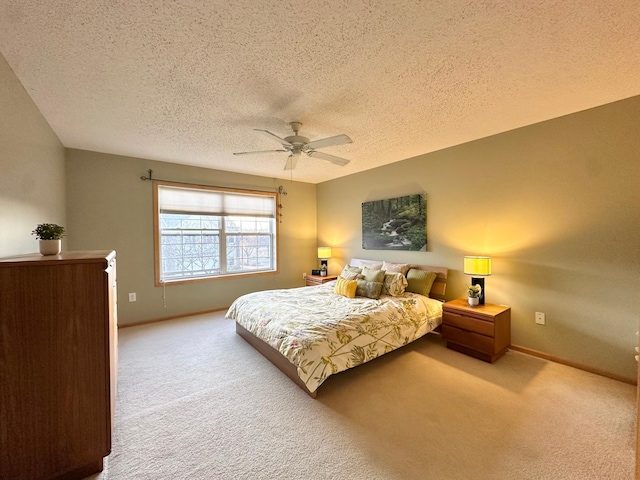 carpeted bedroom with a ceiling fan, a textured ceiling, and baseboards