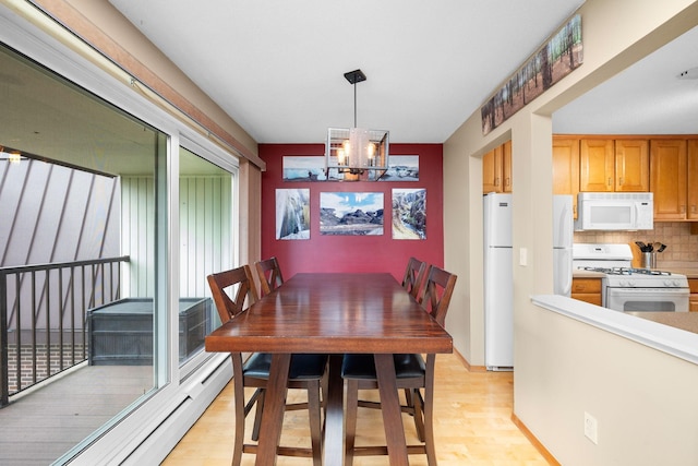 4860 Park Commons Dr Unit 314, Saint Louis Park, MN 55416 - dining space featuring a chandelier, light wood-style flooring, and a baseboard radiator