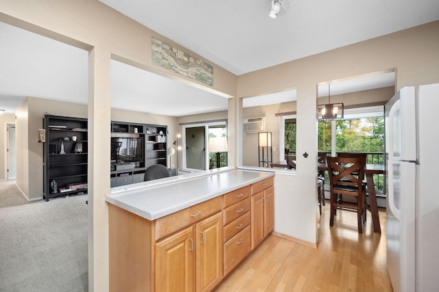 4860 Park Commons Dr Unit 314, Saint Louis Park, MN 55416 - kitchen featuring freestanding refrigerator, plenty of natural light, light countertops, and light wood finished floors