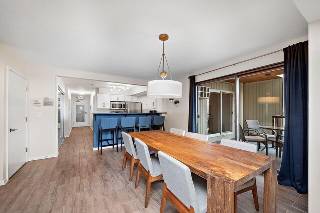 4860 Park Commons Dr Unit 314, Saint Louis Park, MN 55416 - dining room with light wood-style floors and baseboards