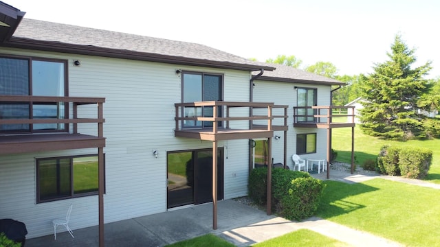 29465 422nd Ave, Otter Tail Twp, MN 56515 - rear view of house with a patio area, a yard, a shingled roof, and a balcony