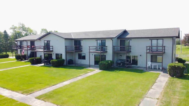 29465 422nd Ave, Otter Tail Twp, MN 56515 - rear view of property featuring a yard, a balcony, a shingled roof, and a patio