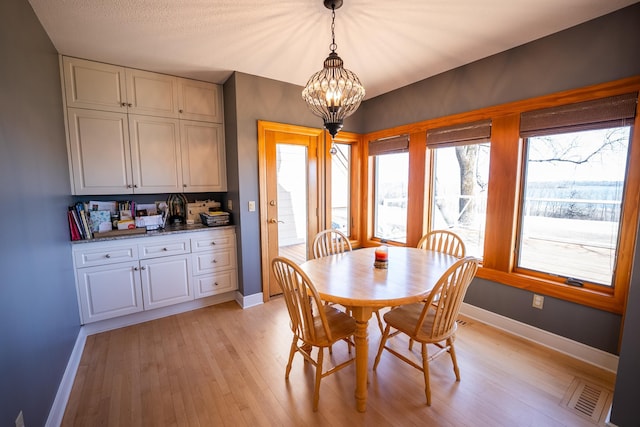 2300 County Road 92, Minnetrista, MN 55359 - dining space with a chandelier, plenty of natural light, and light wood-style flooring