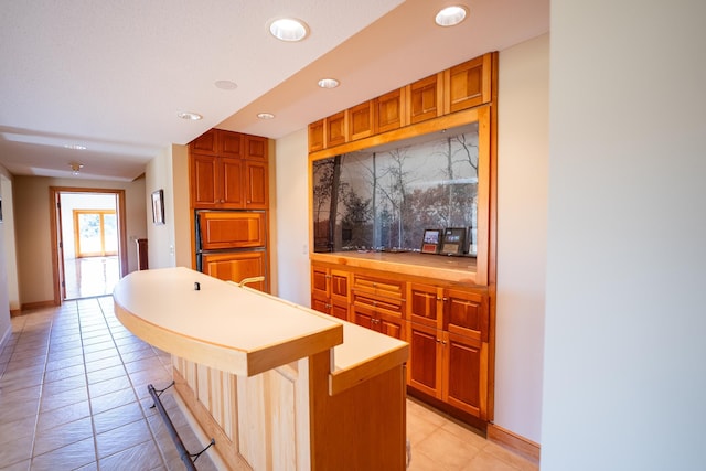 2300 County Road 92, Minnetrista, MN 55359 - kitchen featuring recessed lighting, light countertops, a kitchen breakfast bar, light tile patterned floors, and a kitchen island