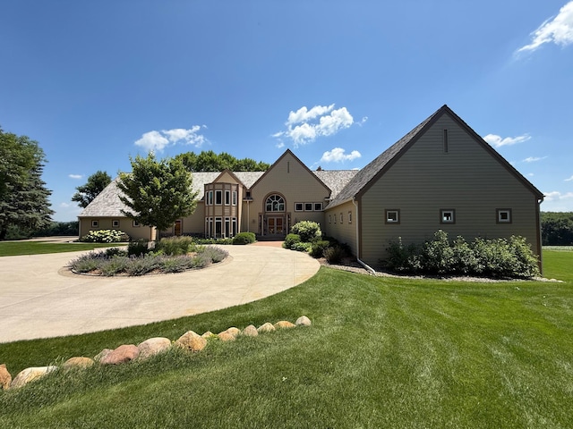 2300 County Road 92, Minnetrista, MN 55359 - tudor-style house with curved driveway and a front lawn