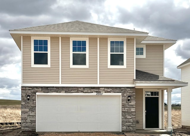 1001 Stone Creek Dr, Jordan, MN 55352 - view of front of home with stone siding, an attached garage, and roof with shingles