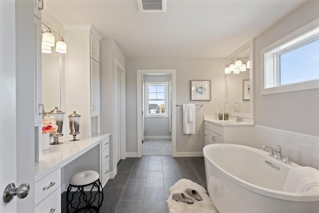3840 Vista View Ct, Chaska, MN 55318 - bathroom featuring plenty of natural light, a soaking tub, vanity, and tile patterned floors