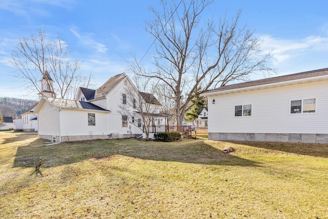 exterior space with a wooden deck and a yard