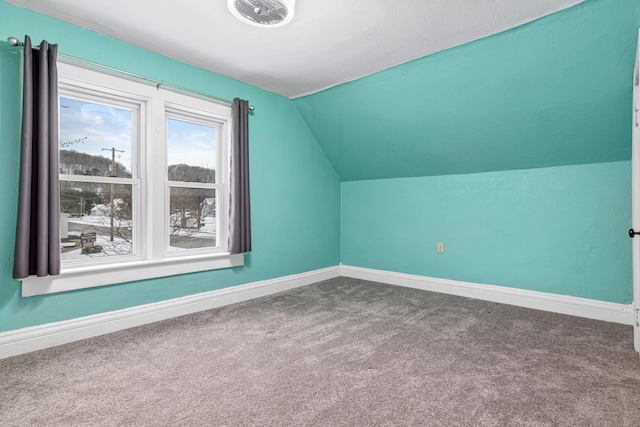 additional living space featuring lofted ceiling, visible vents, carpet floors, and baseboards