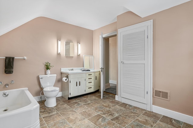 bathroom featuring stone finish floor, visible vents, baseboards, toilet, and a bath