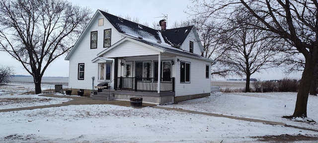 bungalow-style home with a porch and a chimney