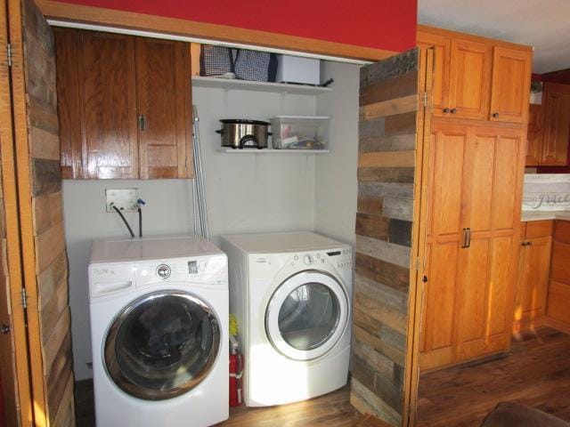 laundry room with wood finished floors and washer and dryer
