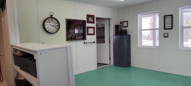 unfurnished room featuring baseboards