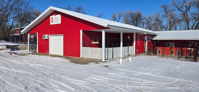 snow covered structure featuring an outdoor structure
