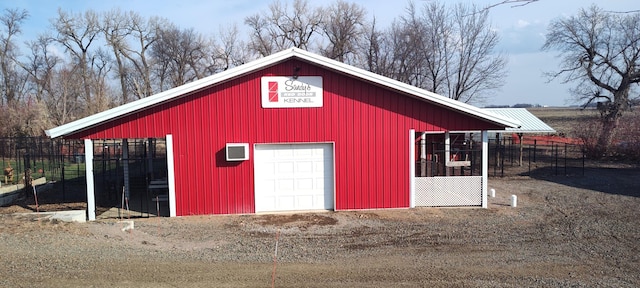 view of outdoor structure featuring an outbuilding and fence