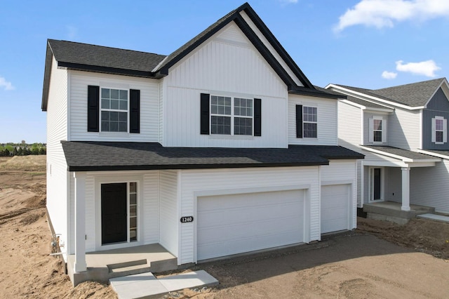view of front facade featuring a garage, roof with shingles, and dirt driveway