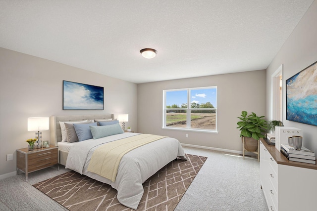 carpeted bedroom with baseboards and a textured ceiling