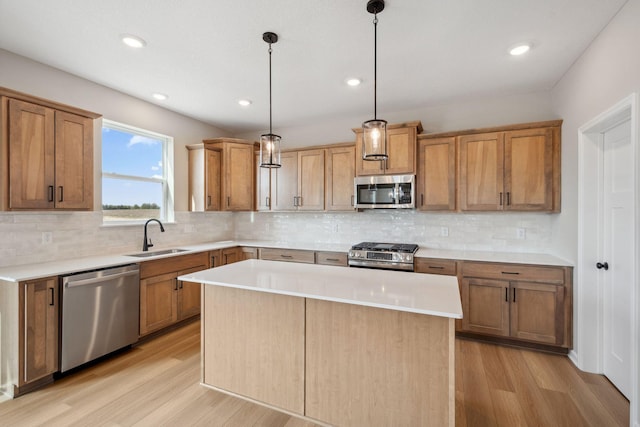 kitchen with stainless steel appliances, a sink, light wood-style flooring, light countertops, and recessed lighting