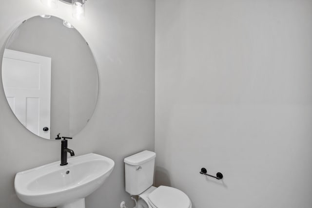 half bathroom with a sink and toilet
