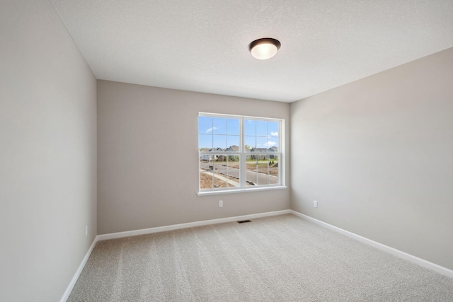 spare room with carpet floors and baseboards