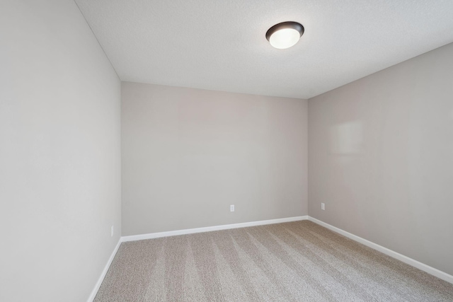 unfurnished room featuring carpet flooring and baseboards