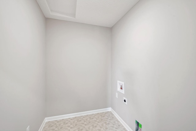 clothes washing area with hookup for a washing machine, hookup for an electric dryer, and baseboards