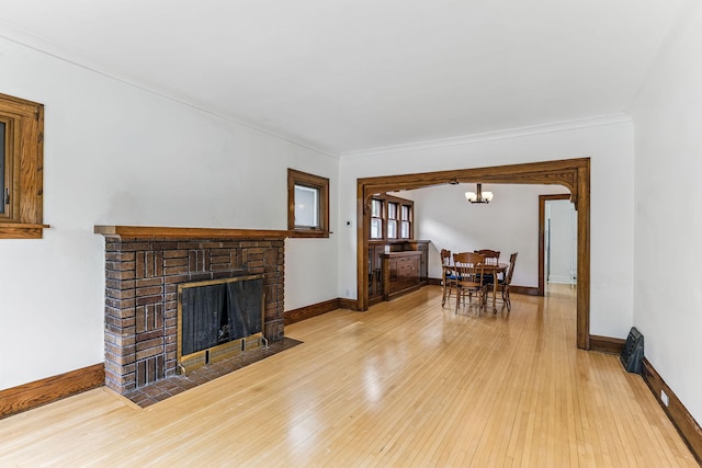 4228 Minnehaha Ave, Minneapolis, MN 55406 - living room with hardwood / wood-style flooring, a fireplace, baseboards, a chandelier, and crown molding