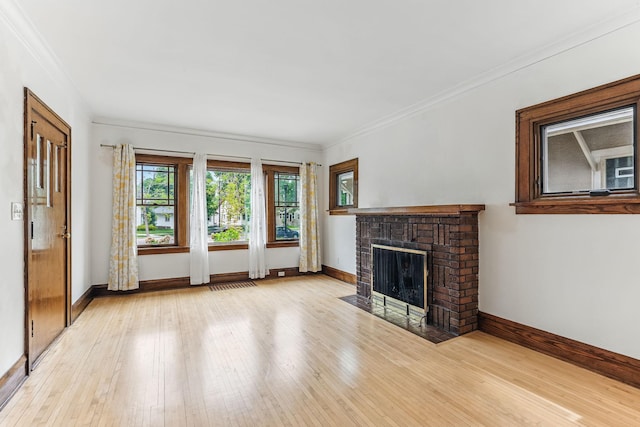 4228 Minnehaha Ave, Minneapolis, MN 55406 - unfurnished living room featuring baseboards, hardwood / wood-style floors, a fireplace, and crown molding