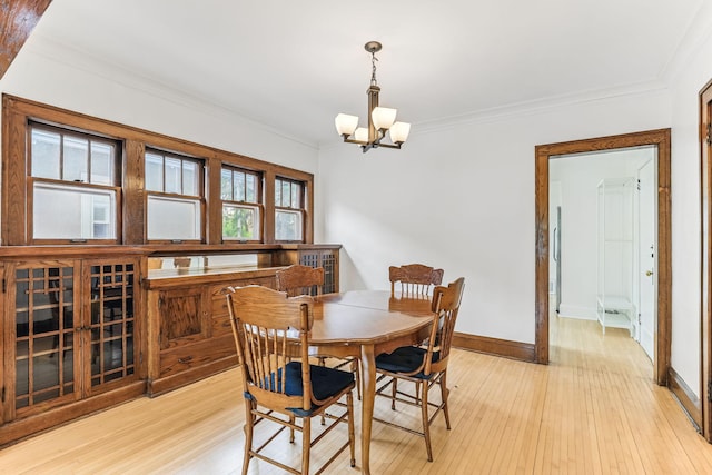 4228 Minnehaha Ave, Minneapolis, MN 55406 - dining room with a chandelier, ornamental molding, light wood finished floors, and baseboards