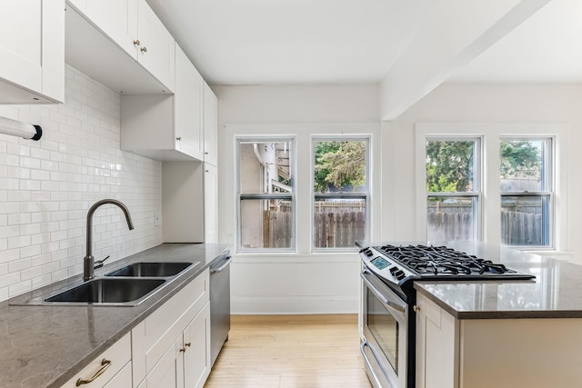 4228 Minnehaha Ave, Minneapolis, MN 55406 - kitchen featuring stainless steel appliances, a sink, light wood-type flooring, and plenty of natural light