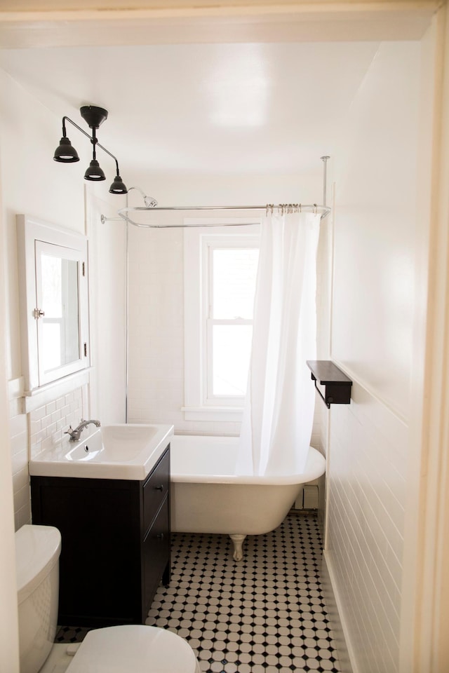 4228 Minnehaha Ave, Minneapolis, MN 55406 - full bath featuring toilet, a tub, plenty of natural light, and vanity