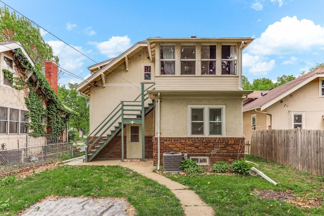 4228 Minnehaha Ave, Minneapolis, MN 55406 - view of front of house with stairway, cooling unit, stucco siding, and brick siding