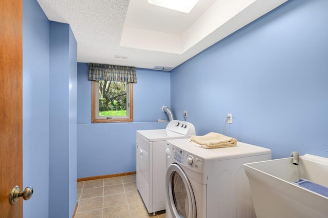 clothes washing area featuring washer and dryer and baseboards
