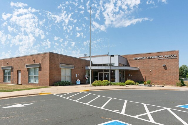view of building exterior with uncovered parking