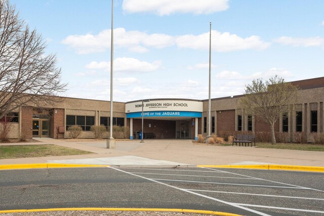view of building exterior featuring uncovered parking