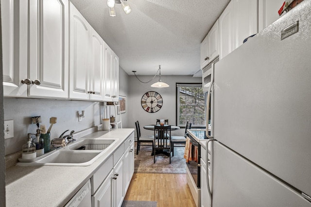 4500 Cedar Lake Rd S Unit 8, Saint Louis Park, MN 55416 - kitchen with white appliances, a sink, white cabinetry, and a textured ceiling