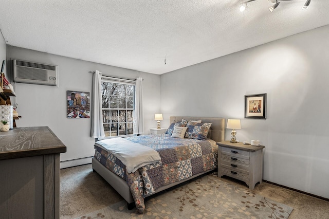 4500 Cedar Lake Rd S Unit 8, Saint Louis Park, MN 55416 - carpeted bedroom featuring a baseboard heating unit, a textured ceiling, an AC wall unit, and baseboards