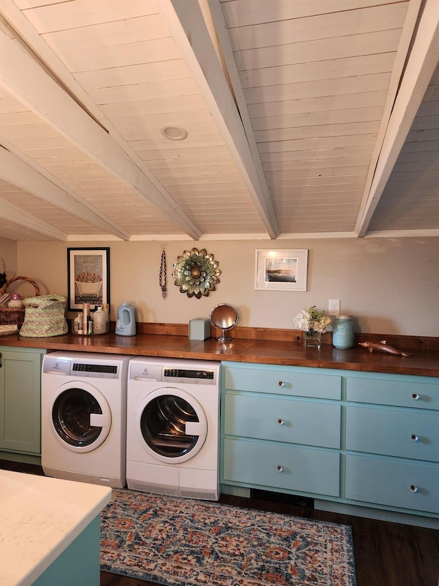 laundry room with wood ceiling, cabinet space, dark wood-style flooring, and washing machine and dryer