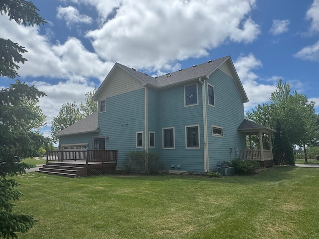 11474 Laketowne Dr, Albertville, MN 55301 - back of property with a lawn, a deck, a shingled roof, and central AC unit